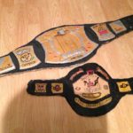Two early cardboard belts I made, the spinner (missing its logo) & my first belt the "Champion of the Unevurce" Belt!